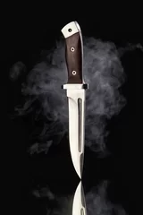 Crédence de cuisine en verre imprimé Chasser Hunting knife with smoke on a black background