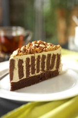 close up coffee cake and white cream on white dish