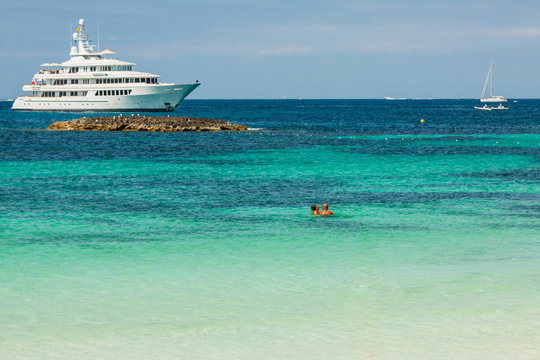 Luxury yachts in turquoise beach of Formentera Illetes