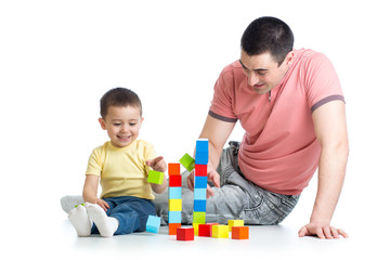 kid and his dad play with building blocks