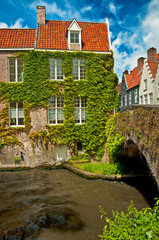Naklejka premium Houses along the canals of Brugge or Bruges, Belgium