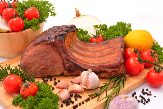 Grilled pork with vegetables on wooden board