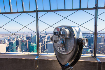 Public telescope pointed on Manhattan buildings