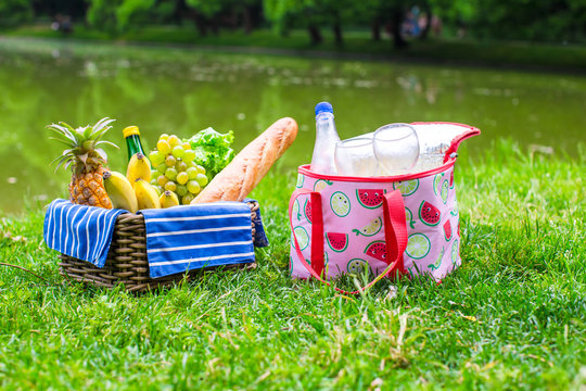 Picnic setting with white wine, pears, fruits, bread