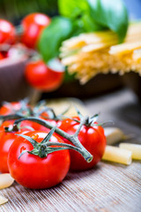 Spaghetti pene cherry tomatoes and basil leaves
