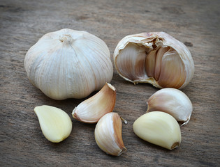 Garlic whole and cloves on the wooden table
