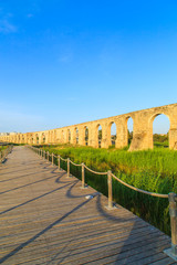 Old Greek aqueduct in warm sunset light in Larnaca, Cyprus