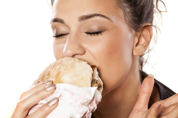 beautiful girl voraciously eating her sandwich