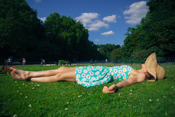 Young woman with hat relaxing in park