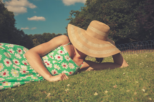 Young woman with hat relaxing in park