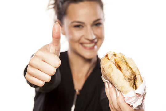 Beautiful Girl Holding A Sandwich And Showing Thumbs Up