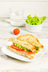 panini sandwiches with salmon, cheese and salad