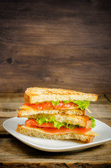 panini sandwiches with salmon, cheese and salad