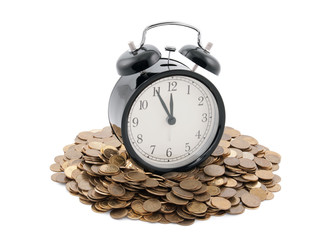 Time is money. Alarm clock with coins. Clipping path included.