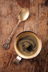 espresso coffee cup on rustic table with sun
