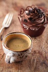 coffee and cupcake in rustic style on wooden table