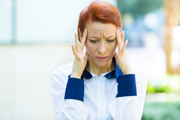 Portrait stressed young businesswoman with headache