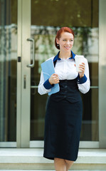 Happy businesswoman leaving her corporate office