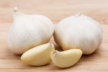 Garlic whole and cloves on the wooden background