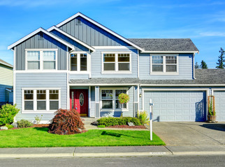 Big two story house. View of entance porch and garage