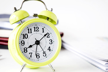 yellow alarm clock on desk