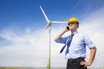 professional business standing with wind generator