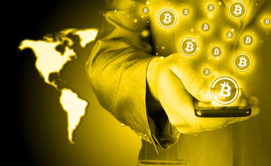 Hand with mobile smart phone and bitcoin symbol