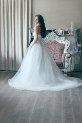 Beautiful bride in white wedding dress of tulle with a corset