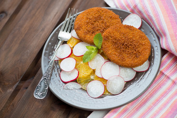 Roasted salmon cutlets with oranges and radish, horizontal shot