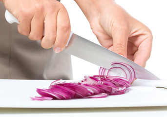 Cook is chopping onion