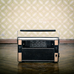 vintage radio receiver device on the weathered wooden parquet fl