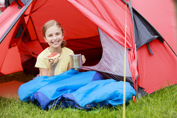 Camp in the tent - young girl on the camping
