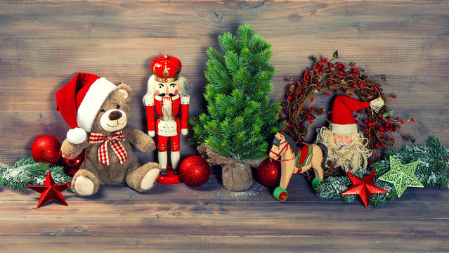 christmas decoration with antique toys teddy bear and nutcracker