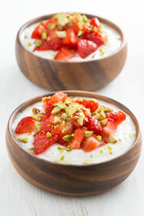 dessert of yogurt with fresh strawberries and pistachios