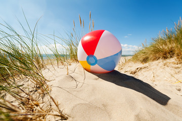 Beach ball in sand dune