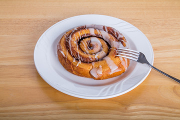 Cinmon Roll on White Plate with Fork