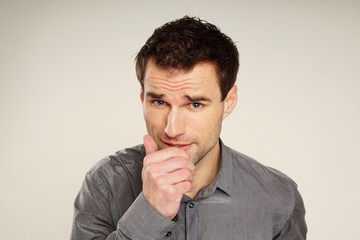 Coughing sick handsome man in gray shirt