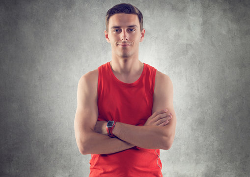 Portrait of muscular young handsome sportsman athlete wearing a