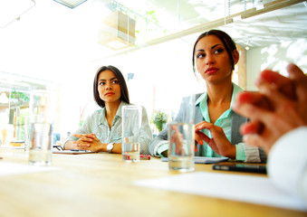 Businesspeople sitting at the table during a meeting in office