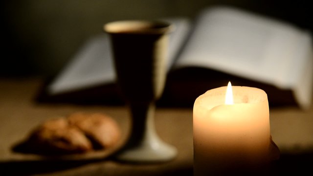 flaming candle and chalice of wine,rack focus