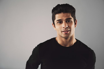 Fototapeta premium Young man in casual t-shirt looking at camera