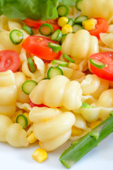 lumaconi pasta by tomatoes sliced
