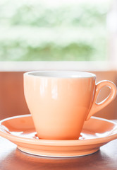 Orange cup of coffee with espresso shot