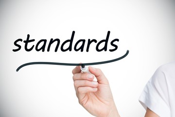 Businesswoman writing the word standards