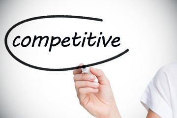 Businesswoman writing the word competitive