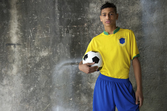 Young Brazilian Footballer In Kit Holding Football