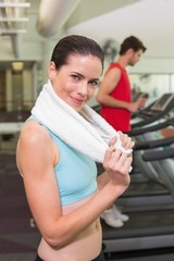 Smiling brunette with towel over shoulders