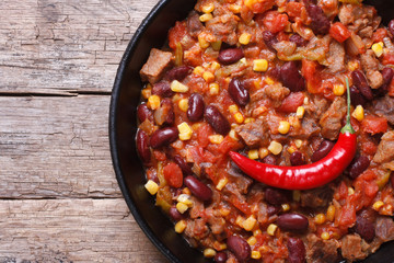 chili con carne close-up in a frying pan top view