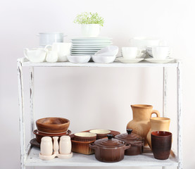 Fototapeta na wymiar Different tableware on shelf, isolated on white