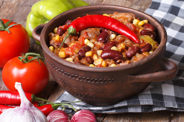 hot chili con carne in a saucepan and ingredients horizontal